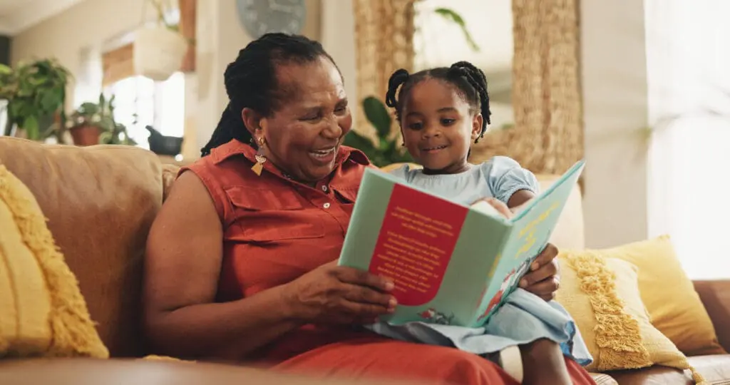 Grandmother reading a book with her grandchild