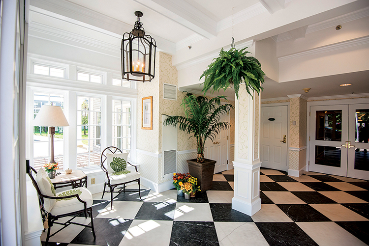 Entryway with black and white checkerboard flooring and hanging plant