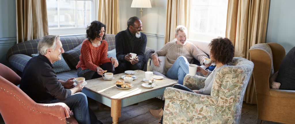 Group of older friends chatting over coffee