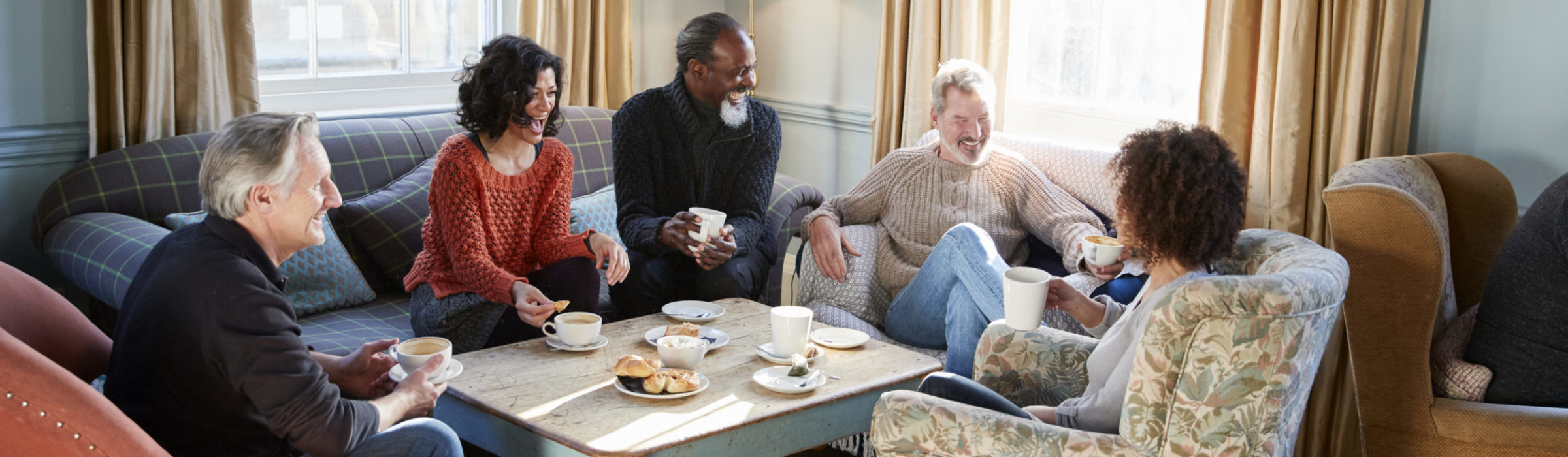 Group of older friends chatting over coffee