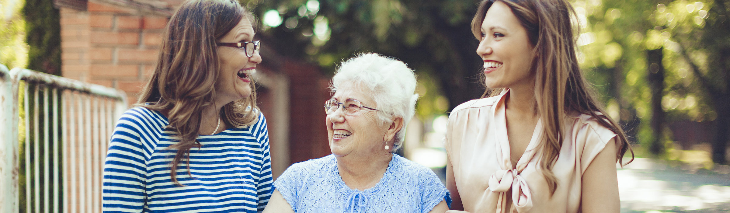 Older woman with her adult grandchildren