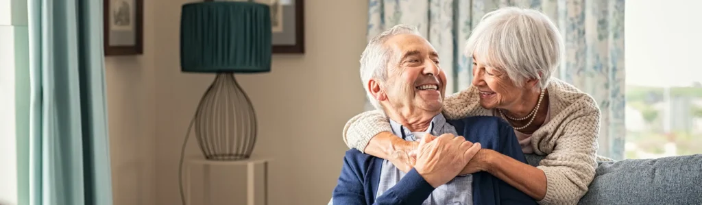 A couple enjoying their apartment at The Village At Duxbury, a senior living community.