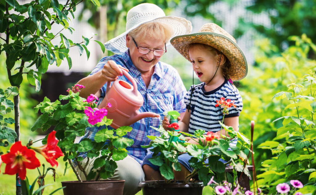 Intergenerational programming consisting of a senior woman gardening with her grandchild