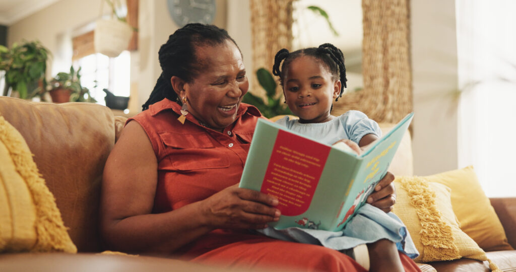 Grandmother reading a book with her grandchild