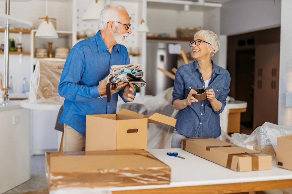 Downsizing for Retirement In Massachusetts: Simplify Your Home, Maximize Your Life 6 A senior couple packing up belonging and downsizing for retirement when moving to The Village at Duxbury.