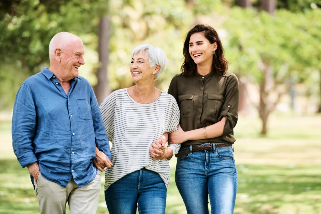Moving to Assisted Living in Massachusetts: How to Prepare, Move, and Feel at Home Faster 2 An adult woman talking with her elderly parents about moving to assisted living at The Village at Duxbury in Massachusetts.