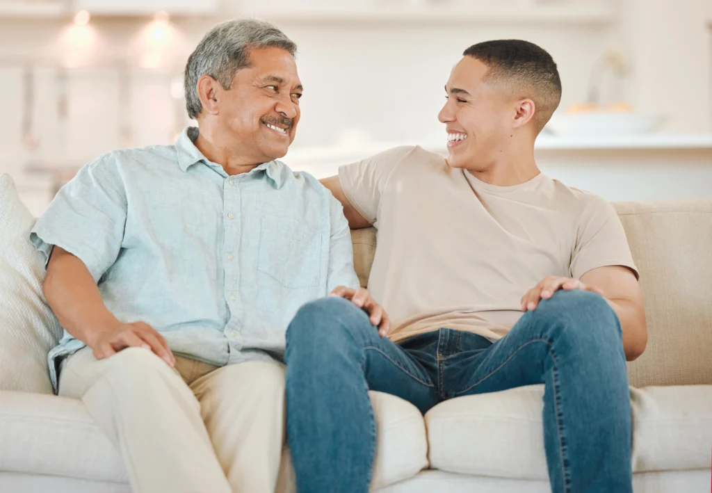 Moving to Assisted Living in Massachusetts: How to Prepare, Move, and Feel at Home Faster 3 An adult son talking with his elderly dad about moving to assisted living in Massachusetts at The Village at Duxbury.
