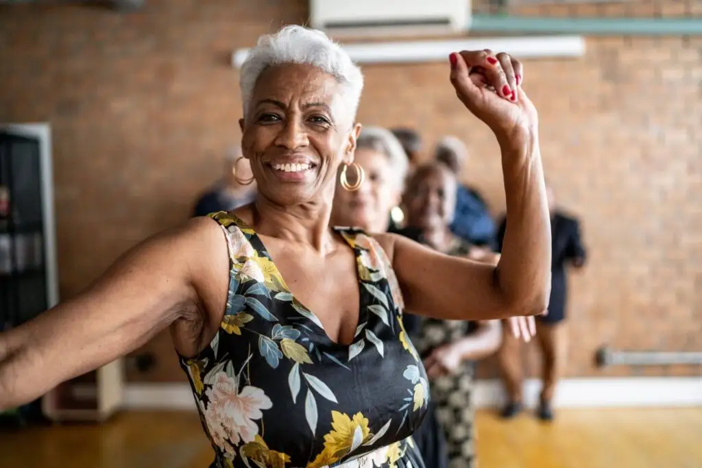 The Psychology Behind Why So Many Retirees Feel Happier After Simplifying Their Lives 3 A senior black woman smiling and stress free after downsizing for retirement at The Village at Duxbury in Duxbury, MA