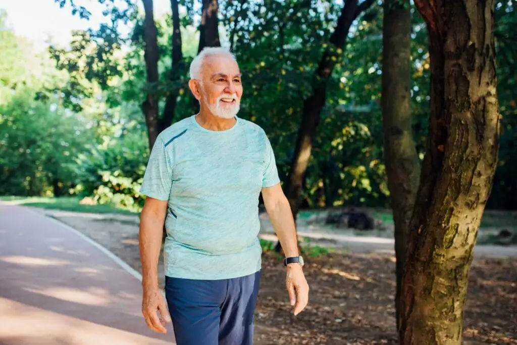Best Senior Living Options for Heart Health Support: A Guide for Seniors & Families 3 An elderly man walking on a trail near The Village at Duxbury, a senior living community that offers great cardiovascular wellness programs in Duxbury, MA.